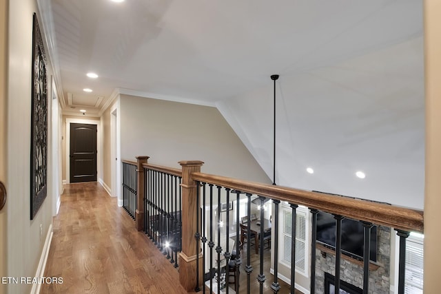 corridor with baseboards, recessed lighting, attic access, and wood finished floors