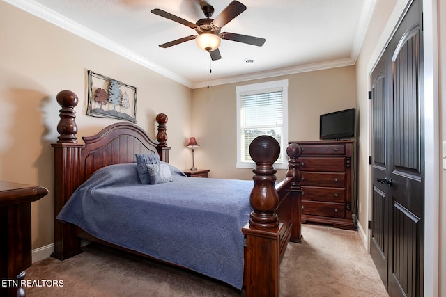 bedroom featuring ornamental molding, light carpet, ceiling fan, and a closet