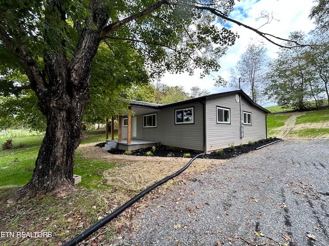 view of property exterior with a lawn