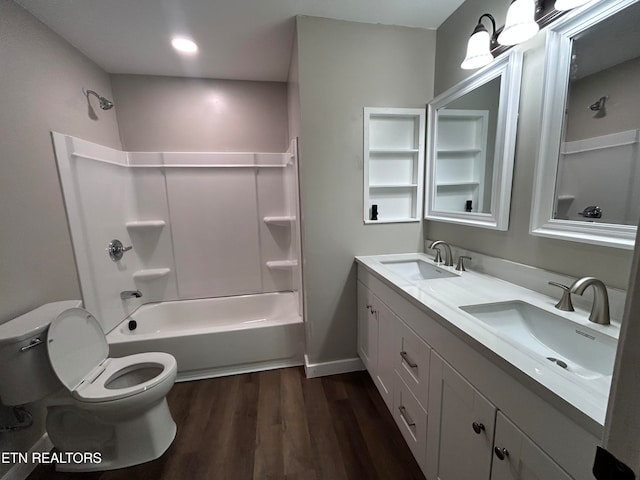 full bathroom with washtub / shower combination, hardwood / wood-style floors, toilet, and vanity