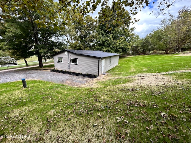 view of outdoor structure featuring a lawn