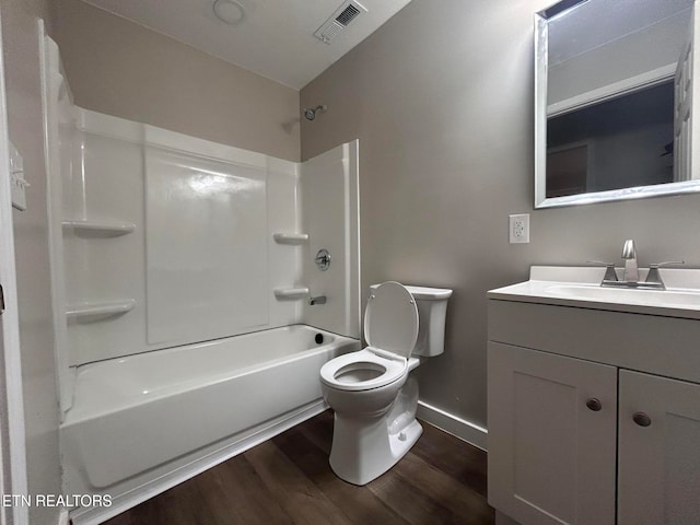 full bathroom featuring wood-type flooring, vanity, toilet, and shower / washtub combination