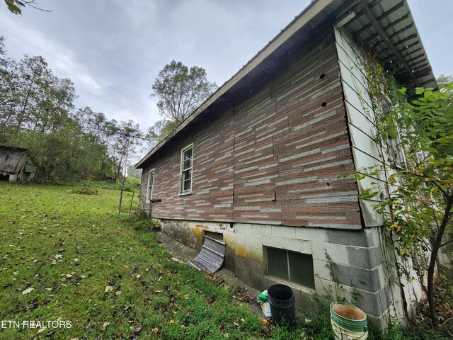 view of side of home featuring a lawn