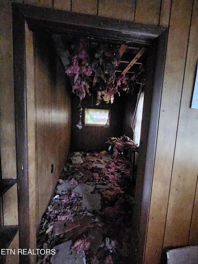 miscellaneous room featuring wooden walls