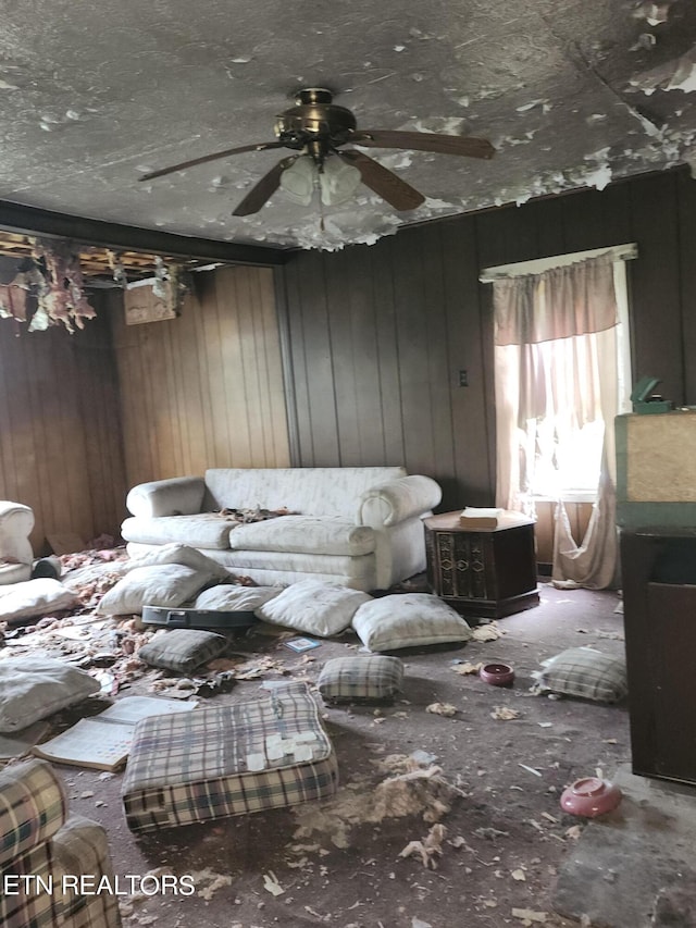 living room with wood walls and ceiling fan