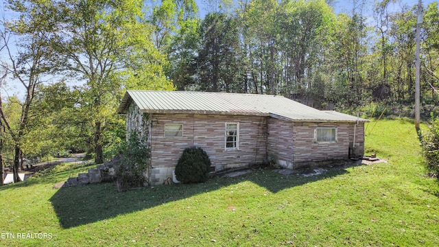 view of side of property with a lawn