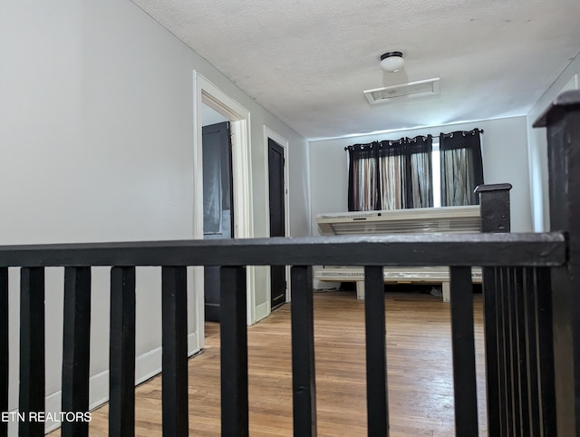 interior space with wood finished floors and a textured ceiling