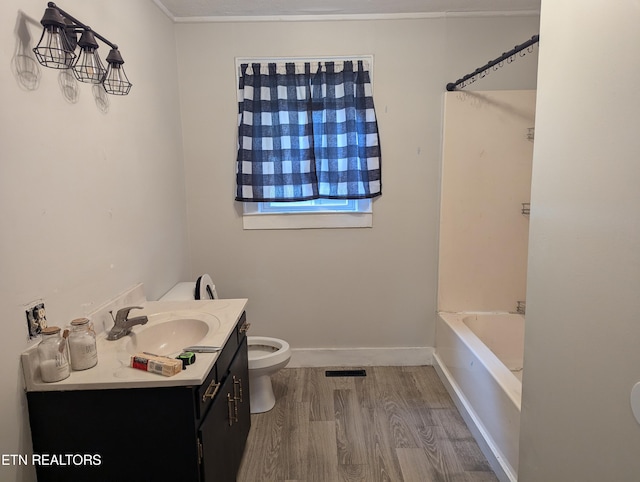 bathroom with visible vents, toilet, wood finished floors, baseboards, and vanity