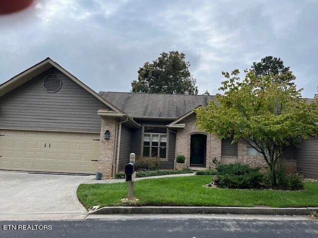 view of front of house with a garage and a front yard