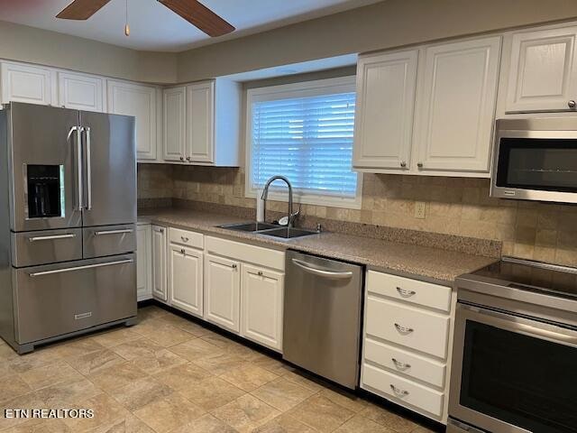 kitchen with white cabinetry, appliances with stainless steel finishes, and sink