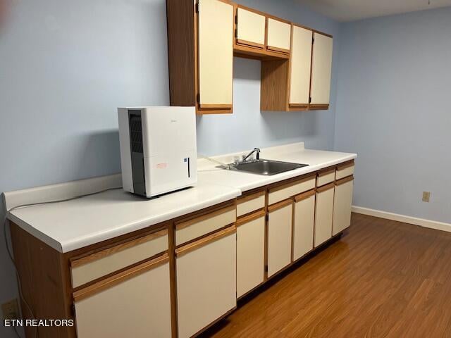 kitchen with sink and light hardwood / wood-style floors