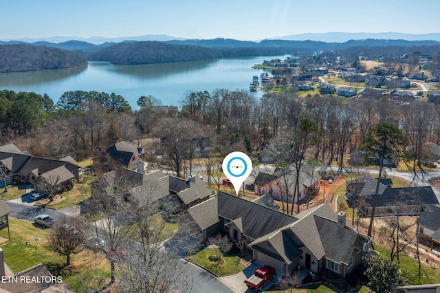 drone / aerial view with a water and mountain view