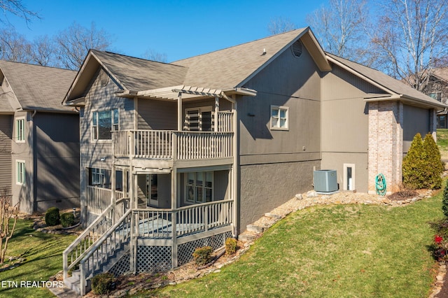 rear view of house featuring a balcony, a pergola, stairs, central air condition unit, and a lawn