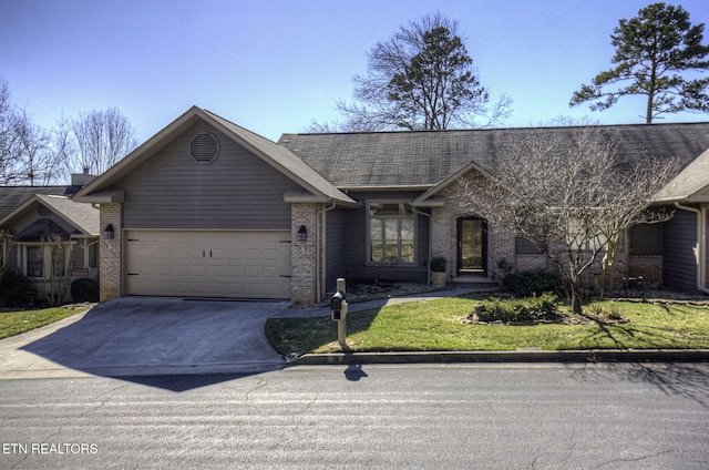 ranch-style house with brick siding, driveway, a front lawn, and a garage