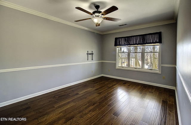 spare room with visible vents, dark wood-type flooring, ornamental molding, a ceiling fan, and baseboards