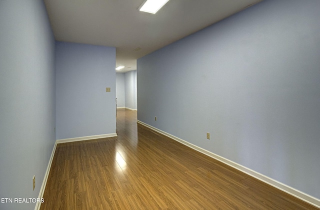 unfurnished room featuring wood finished floors and baseboards