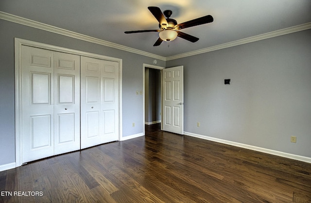 unfurnished bedroom featuring crown molding, ceiling fan, baseboards, a closet, and dark wood-style floors