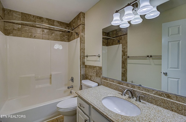 bathroom featuring shower / bath combination, toilet, tile walls, and vanity