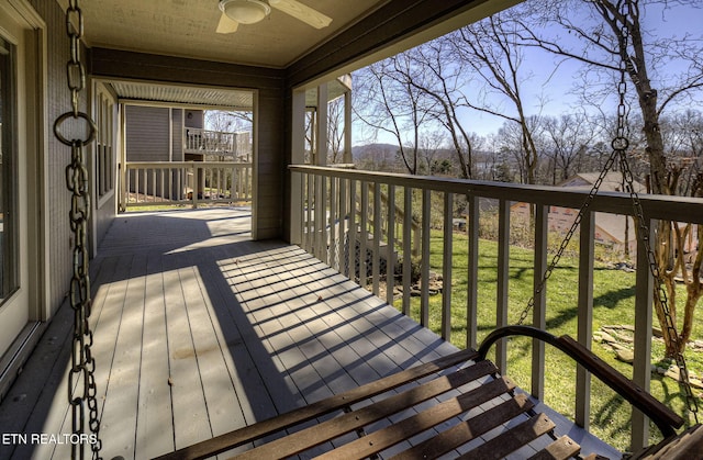 deck featuring a yard and a ceiling fan