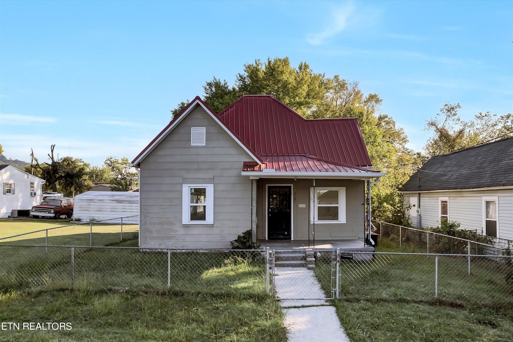 bungalow-style house with a front yard