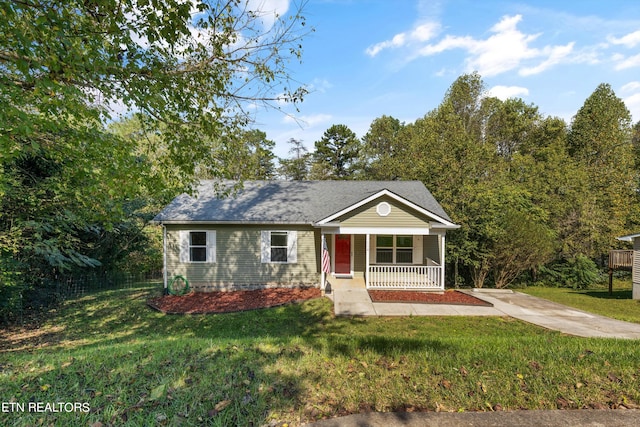 single story home featuring covered porch and a front yard