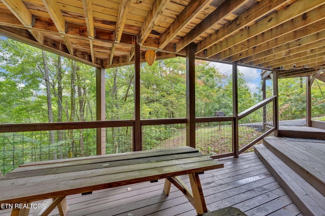 unfurnished sunroom featuring wooden ceiling