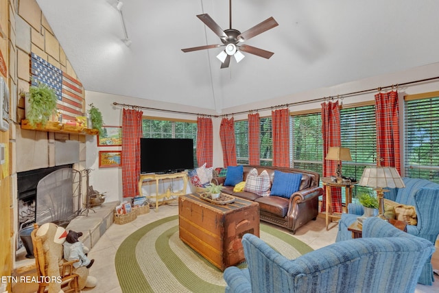 living room with high vaulted ceiling, ceiling fan, and a fireplace