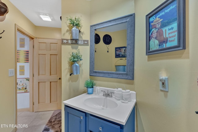 bathroom featuring tile patterned flooring and vanity