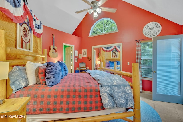 bedroom with ceiling fan, light tile patterned floors, and high vaulted ceiling