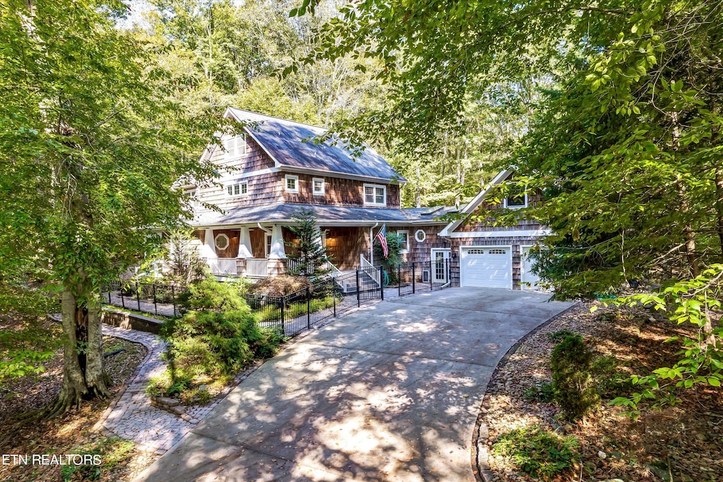 view of front of property featuring covered porch and a garage