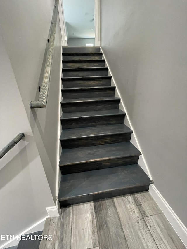 stairs featuring baseboards and wood finished floors