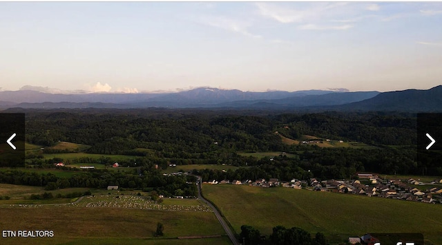 aerial view at dusk featuring a mountain view