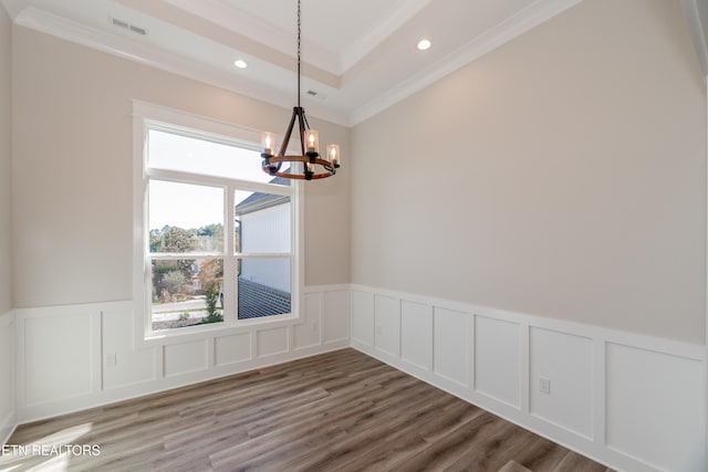 unfurnished dining area with visible vents, wood finished floors, an inviting chandelier, crown molding, and recessed lighting