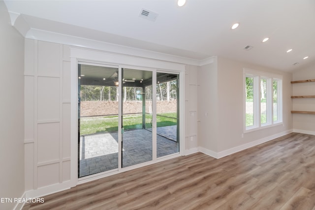 unfurnished room featuring light wood-type flooring, baseboards, visible vents, and recessed lighting