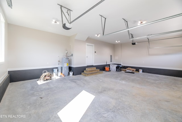 garage featuring a garage door opener and water heater