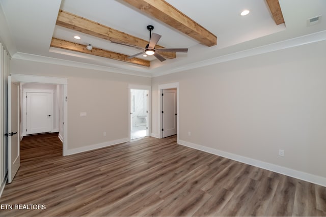 spare room with beamed ceiling, ceiling fan, a raised ceiling, hardwood / wood-style flooring, and crown molding