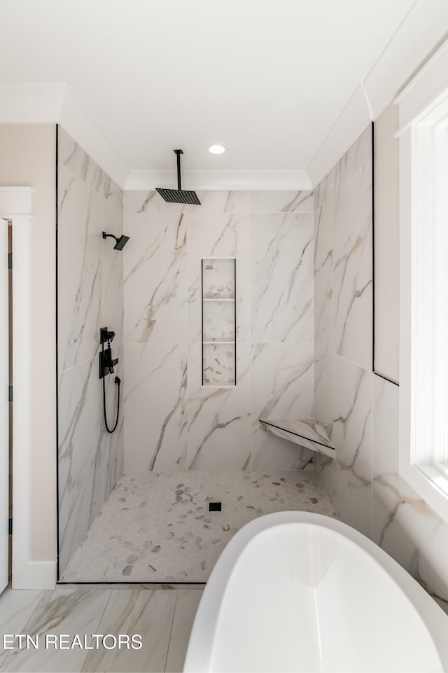 bathroom featuring crown molding, separate shower and tub, and tile walls