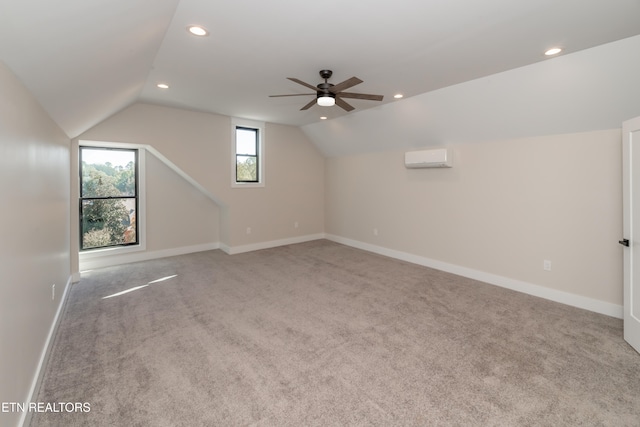 additional living space featuring light carpet, ceiling fan, vaulted ceiling, and a wall mounted AC