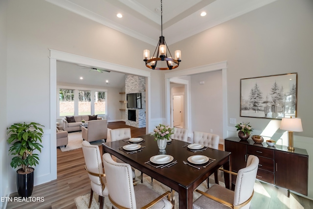 dining space featuring light wood-style floors, a notable chandelier, and recessed lighting