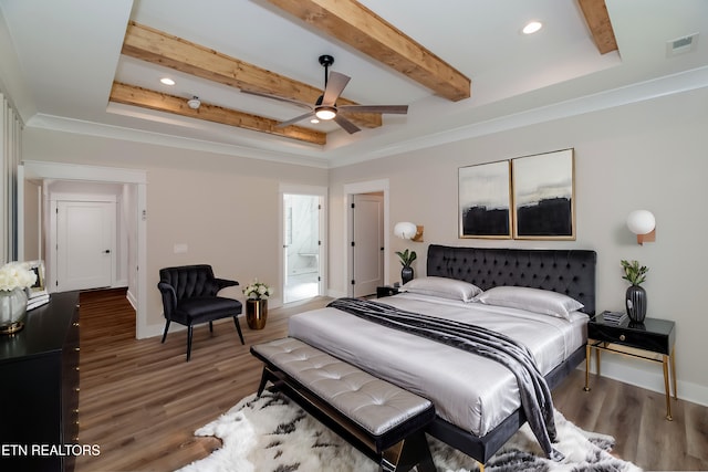 bedroom featuring baseboards, visible vents, beam ceiling, and wood finished floors