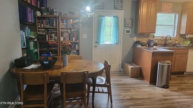 dining room featuring light wood-type flooring and sink