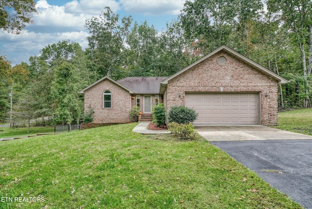 ranch-style home with a garage and a front yard