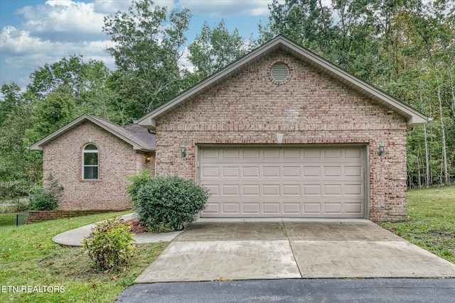 front of property with a garage and a front lawn