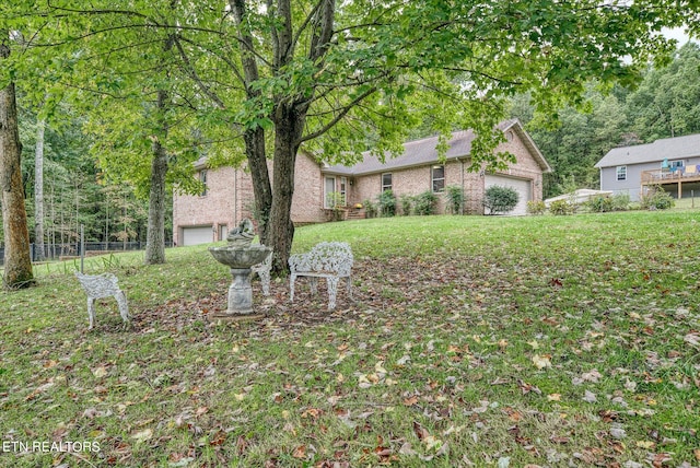 view of front facade with a garage and a front lawn