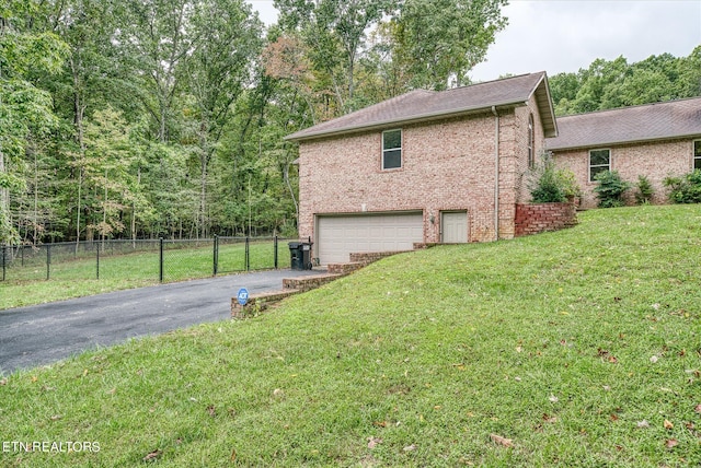 view of property exterior with a garage and a yard