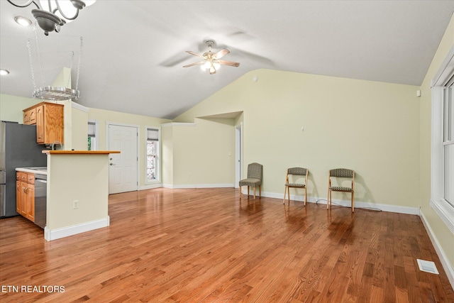 unfurnished living room featuring light hardwood / wood-style floors, ceiling fan, and lofted ceiling