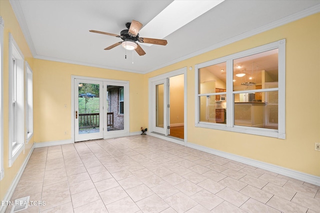 unfurnished sunroom with ceiling fan