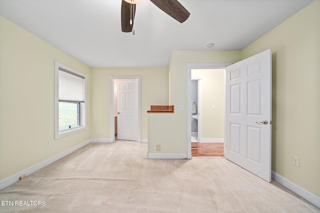 unfurnished bedroom with light carpet and ceiling fan