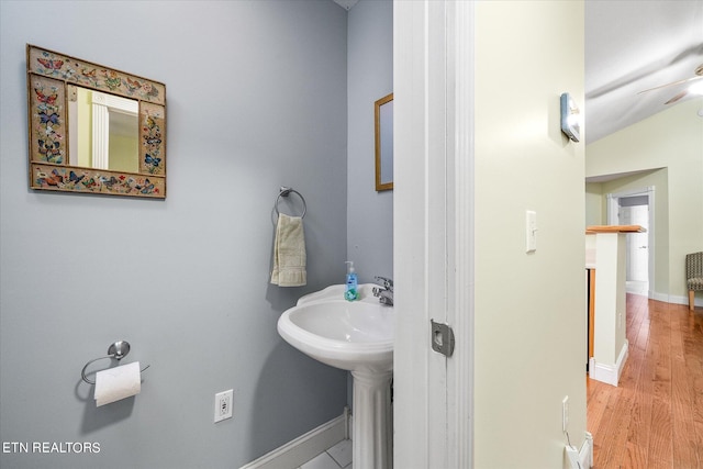 bathroom with wood-type flooring, ceiling fan, and lofted ceiling