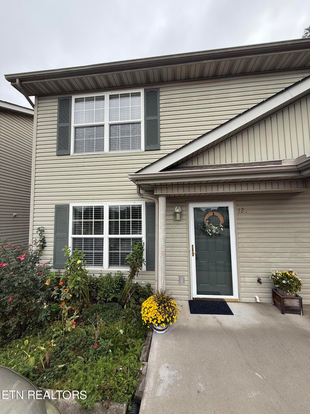 view of exterior entry with a patio